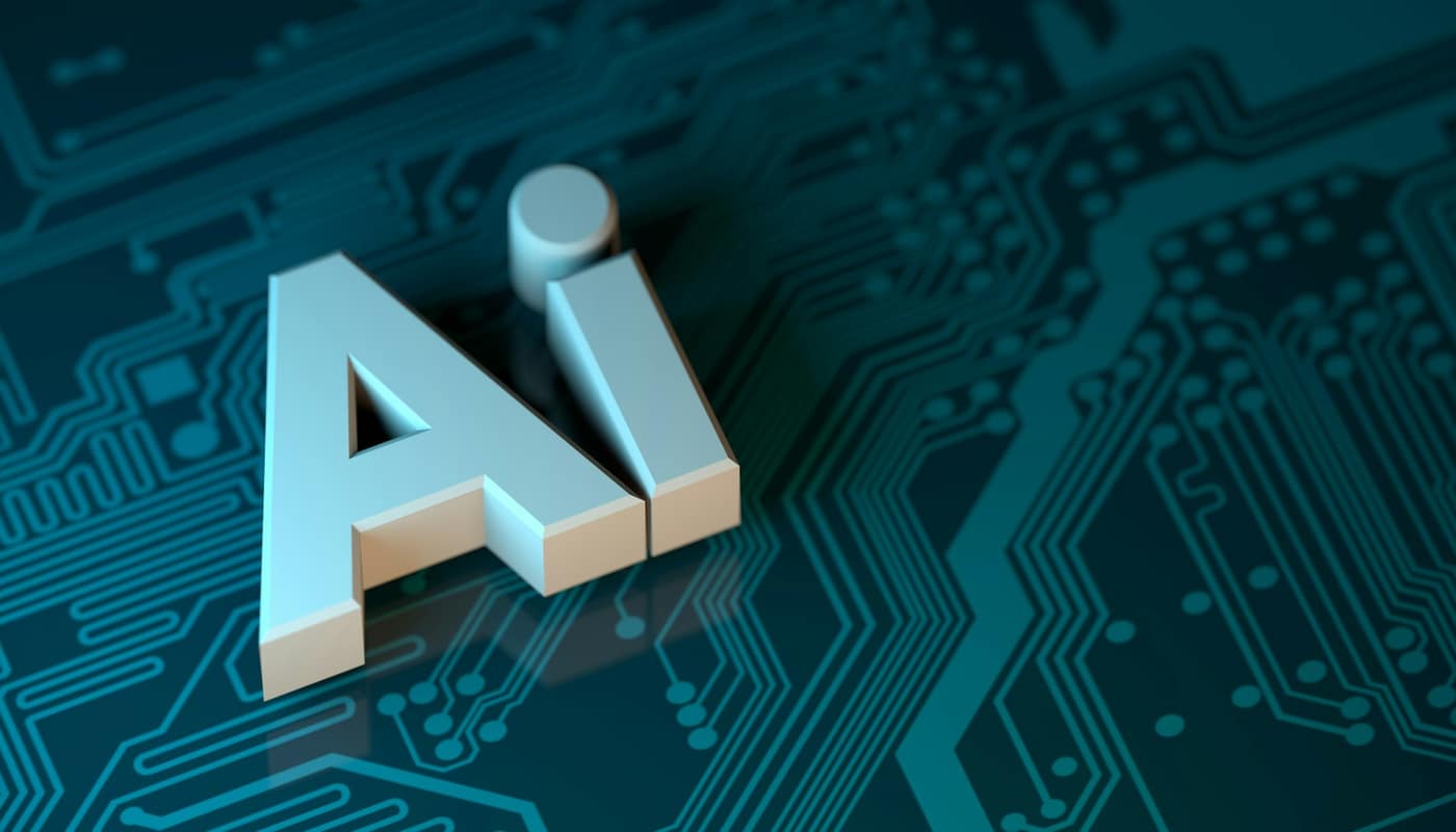 The letters AI in 3D above a teal circuit board