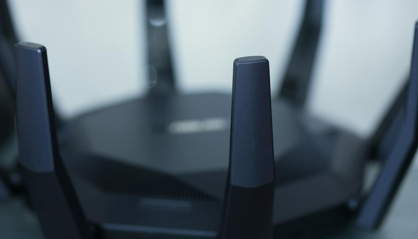 A black Wi-Fi router with several antennas, seen close up